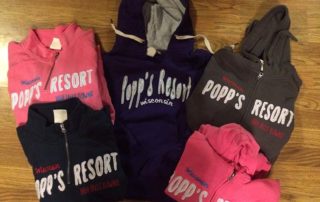Pink, Black, and Brown Popp's Resort hooded sweater.