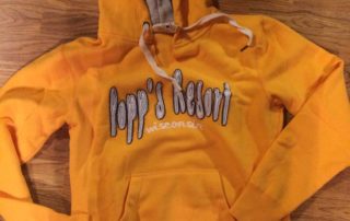 Orange Popp's Resort hooded sweater.